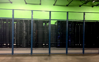 Data racks enclosed in a secure caged area.