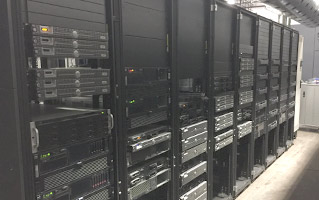 Row of server racks in a data center.